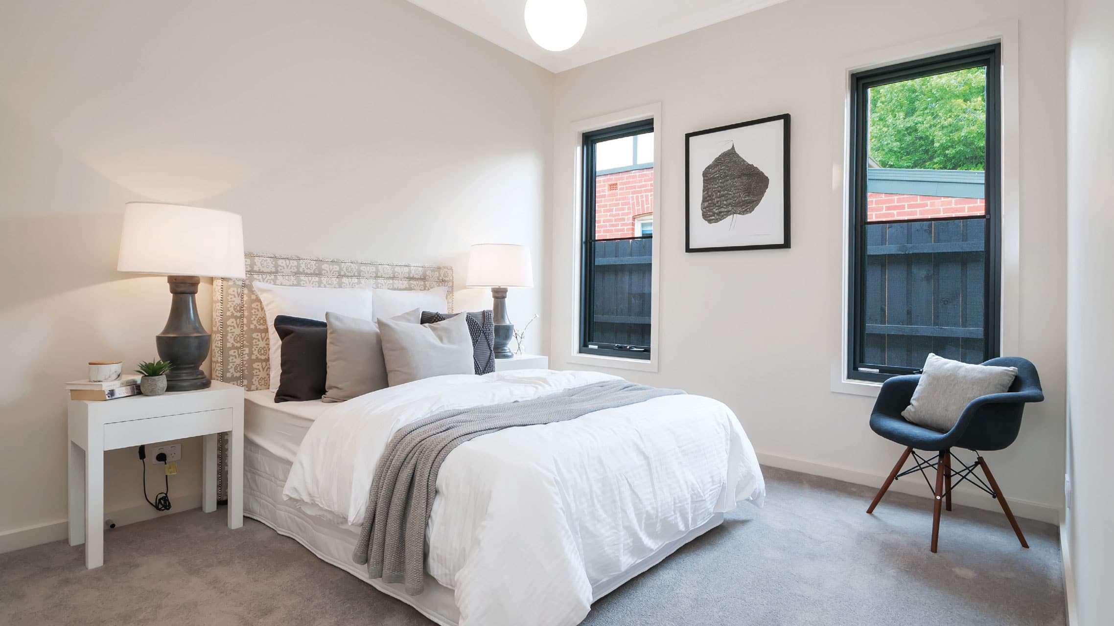 Two Black Aluminium Awning Windows in a bedroom