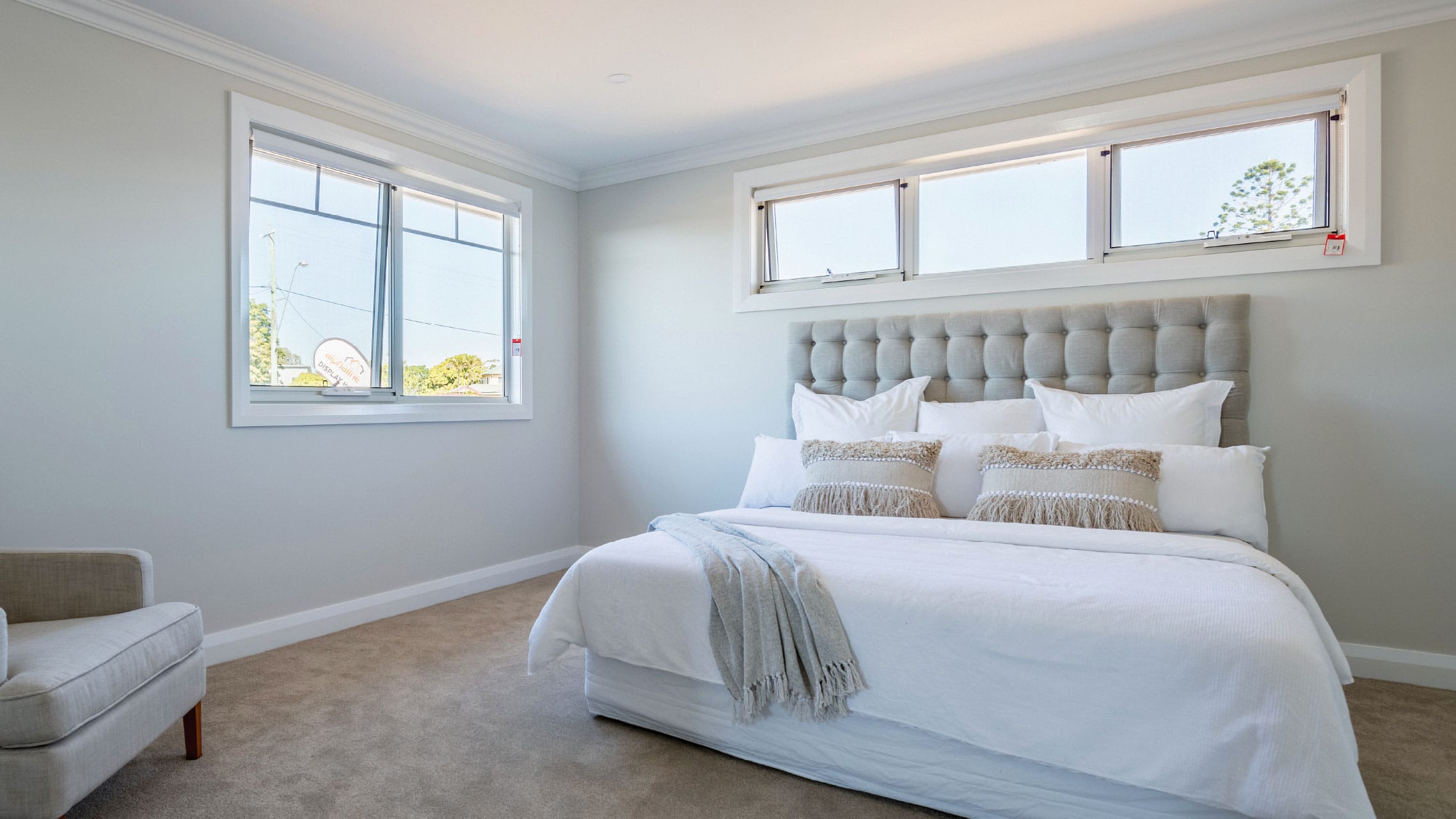 Two White Aluminium Awning Windows in a bedroom