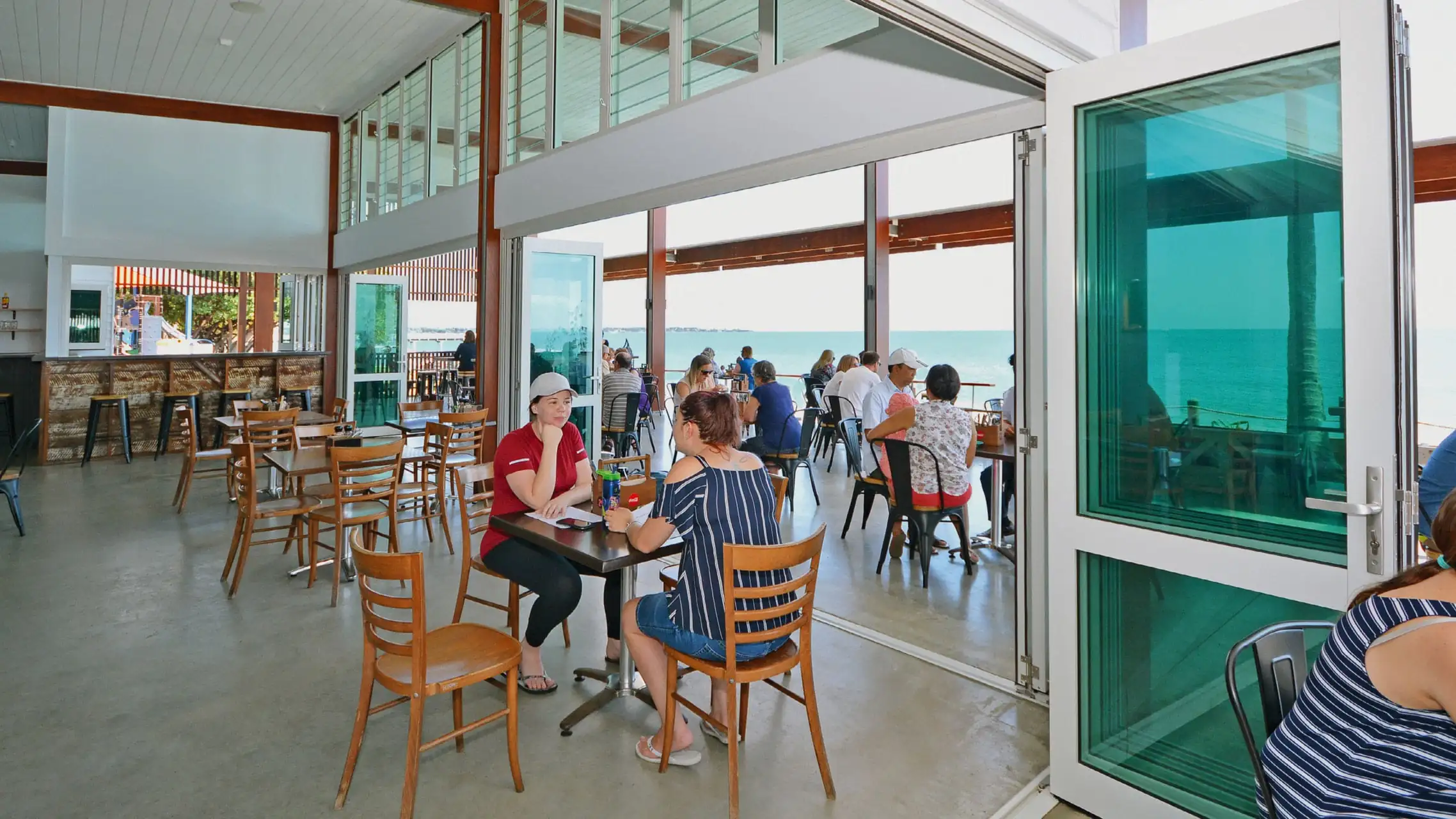 White Aluminium Bi fold Doors with green glass