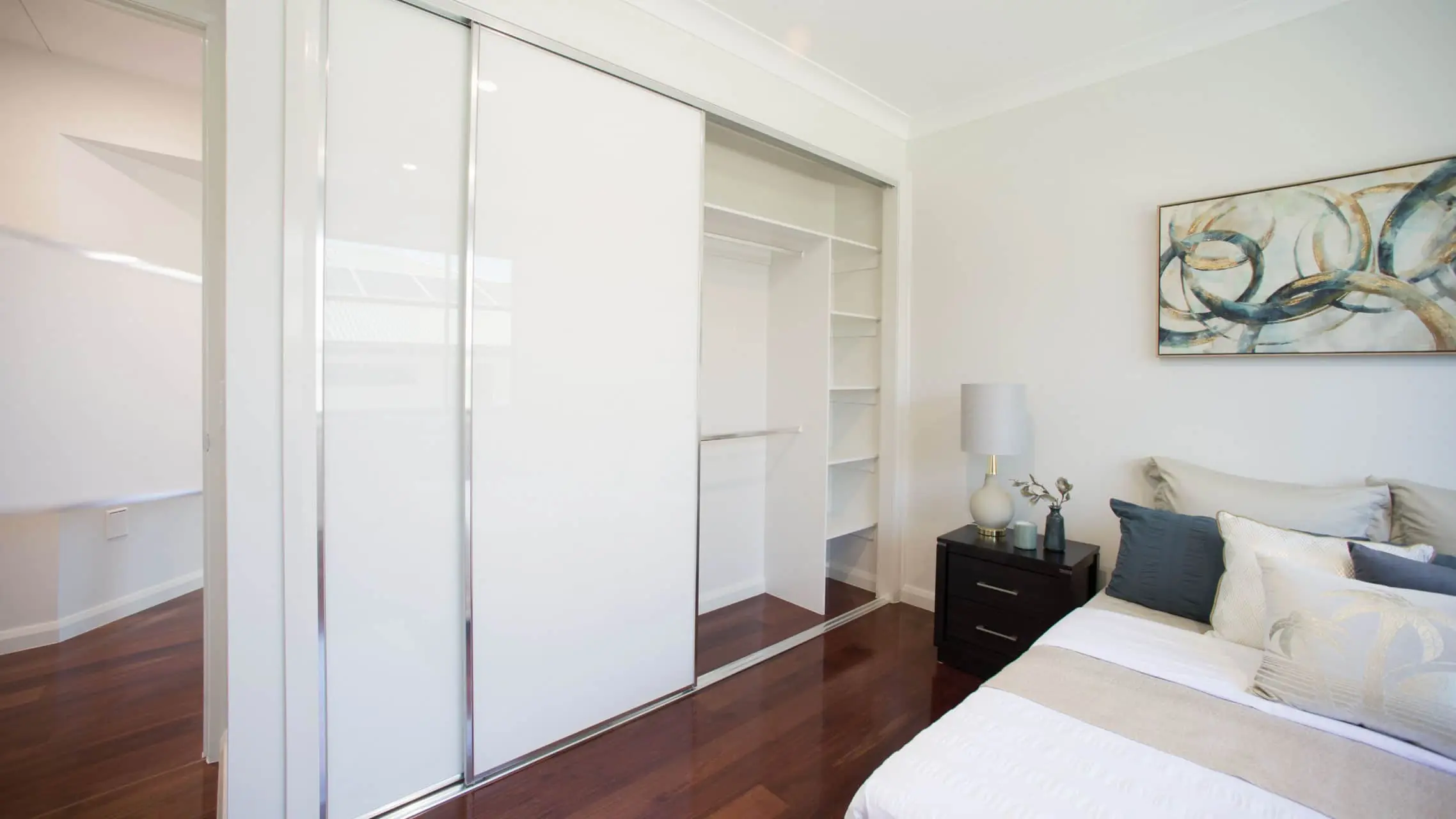 Coloured Glass Sliding Wardrobe Doors in a bedroom