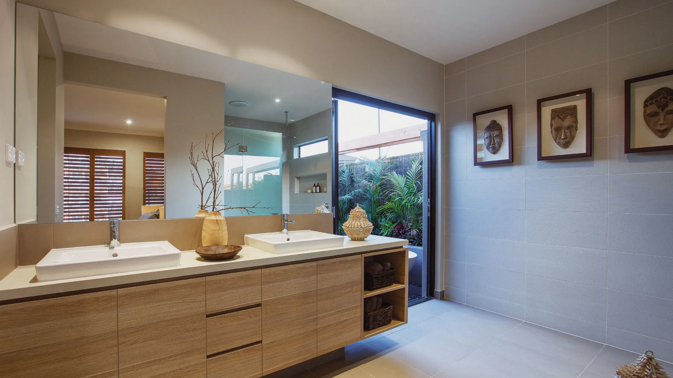 Large Frameless Bathroom Mirror above a vanity next to a bi fold door