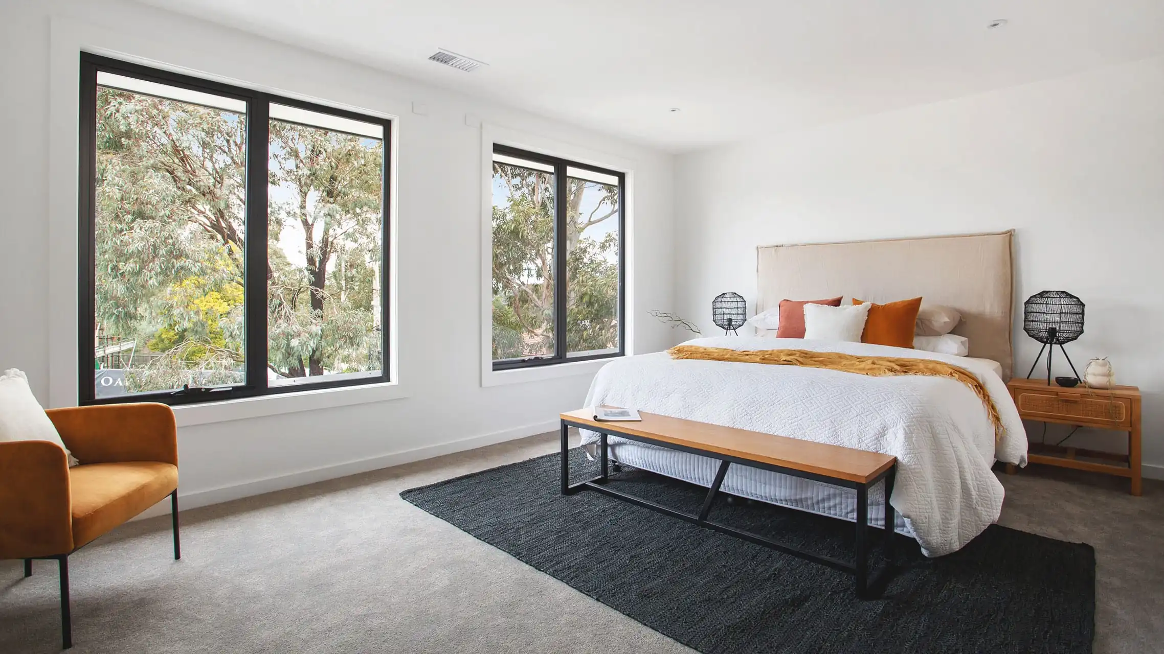 Two Black Awning Windows in a bedroom